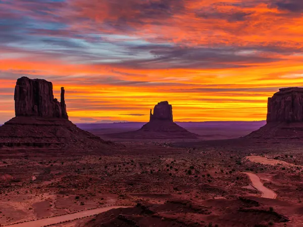 Desert buttes under a glowing sunset